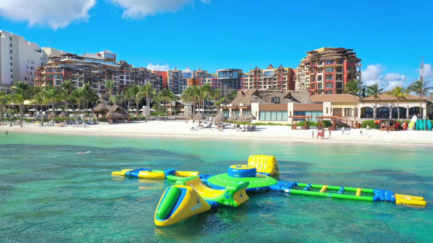 Beachfront resort buildings and floating water park at Villa del Palmar Cancun Beach Resort & Spa.