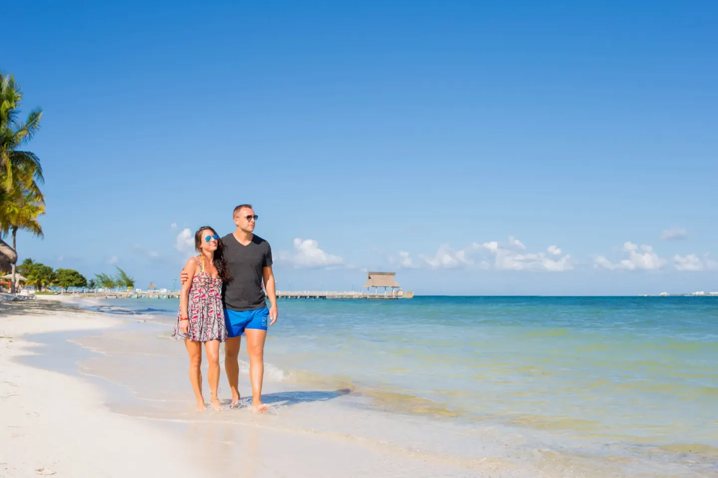 Couple walking along the beach at Villa del Palmar Cancun Beach Resort & Spa.