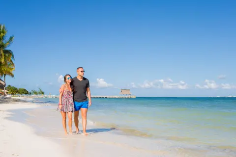Couple walking along the beach at Villa del Palmar Cancun Beach Resort & Spa.