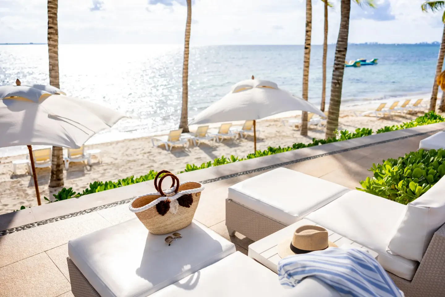 White terrace seating overlooking the beach at Villa del Palmar Cancun Beach Resort & Spa.