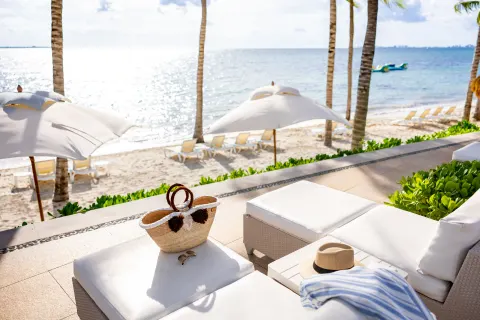 White terrace seating overlooking the beach at Villa del Palmar Cancun Beach Resort & Spa.