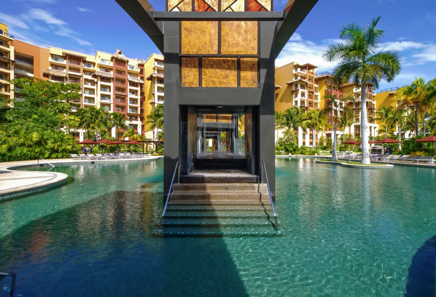 Central pool walkway between resort buildings at Villa del Palmar Cancun Beach Resort & Spa.