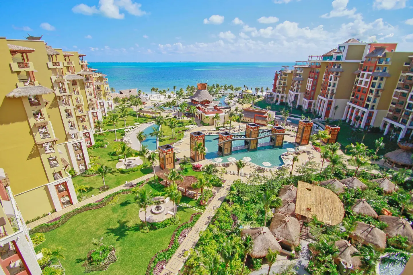 High-angle view of pools, gardens, and the ocean at Villa del Palmar Cancun Beach Resort & Spa.