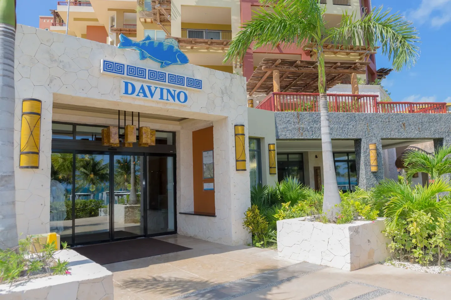 Davino entrance sign and palm landscaping at Villa del Palmar Cancun Beach Resort & Spa.