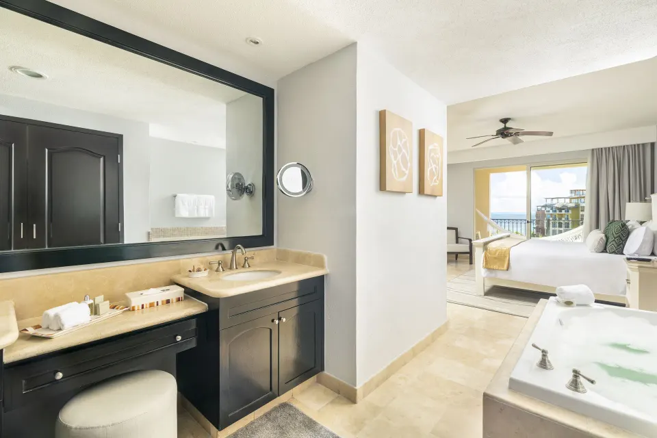 One Bedroom Ocean View bathroom and king bed at Villa del Palmar Cancun Beach Resort & Spa.