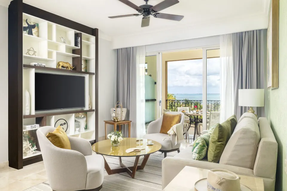 One Bedroom Ocean View living room with sofa and balcony at Villa del Palmar Cancun Beach Resort & Spa.
