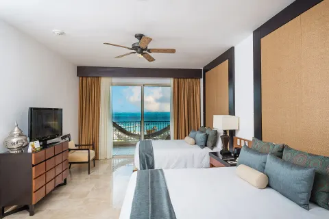 Three Bedroom Loft bedroom with two beds and balcony view at Villa del Palmar Cancun Beach Resort & Spa.