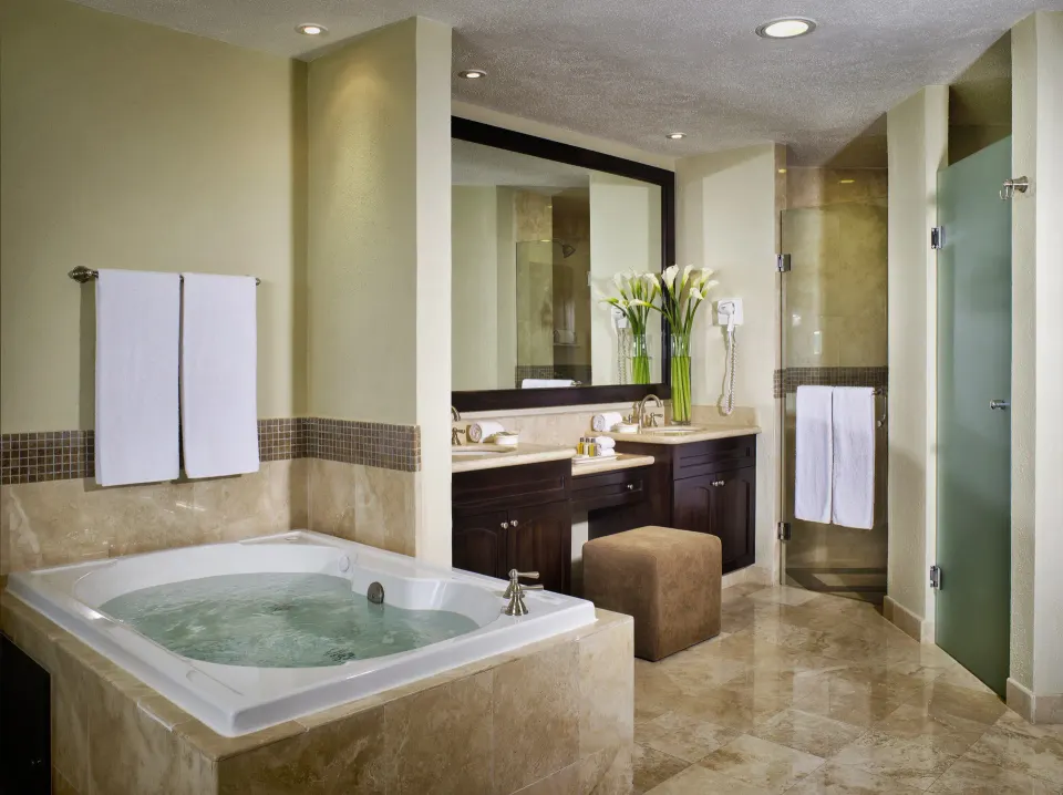 Two Bedroom Ocean Front bathroom with tub and shower at Villa del Palmar Cancun Beach Resort & Spa.