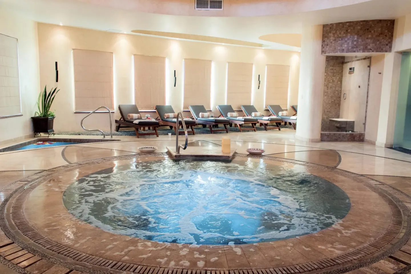 Circular spa pool with surrounding loungers at Villa Del Palmar Flamingos Beach Resort and Spa.