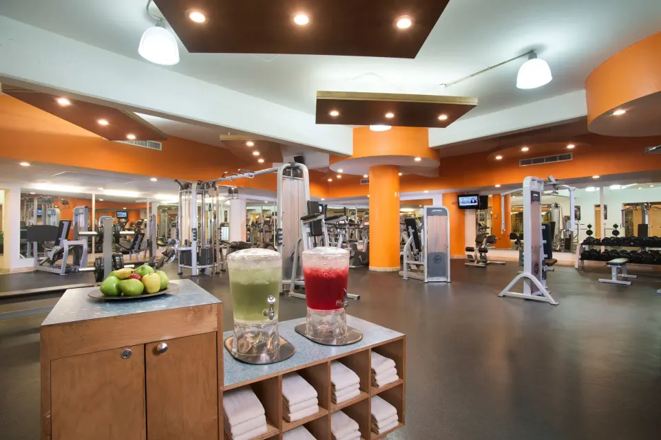 Fitness center with equipment and refreshment dispensers at Villa Del Palmar Flamingos Beach Resort and Spa.