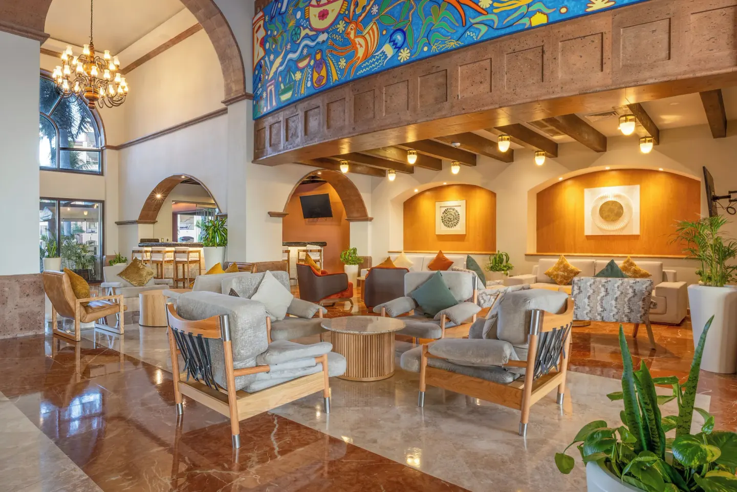 Spacious lobby lounge with colorful mural at Villa Del Palmar Flamingos Beach Resort and Spa.