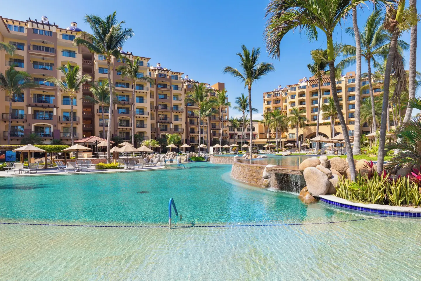 Main pool with palms and waterfalls at Villa Del Palmar Flamingos Beach Resort and Spa