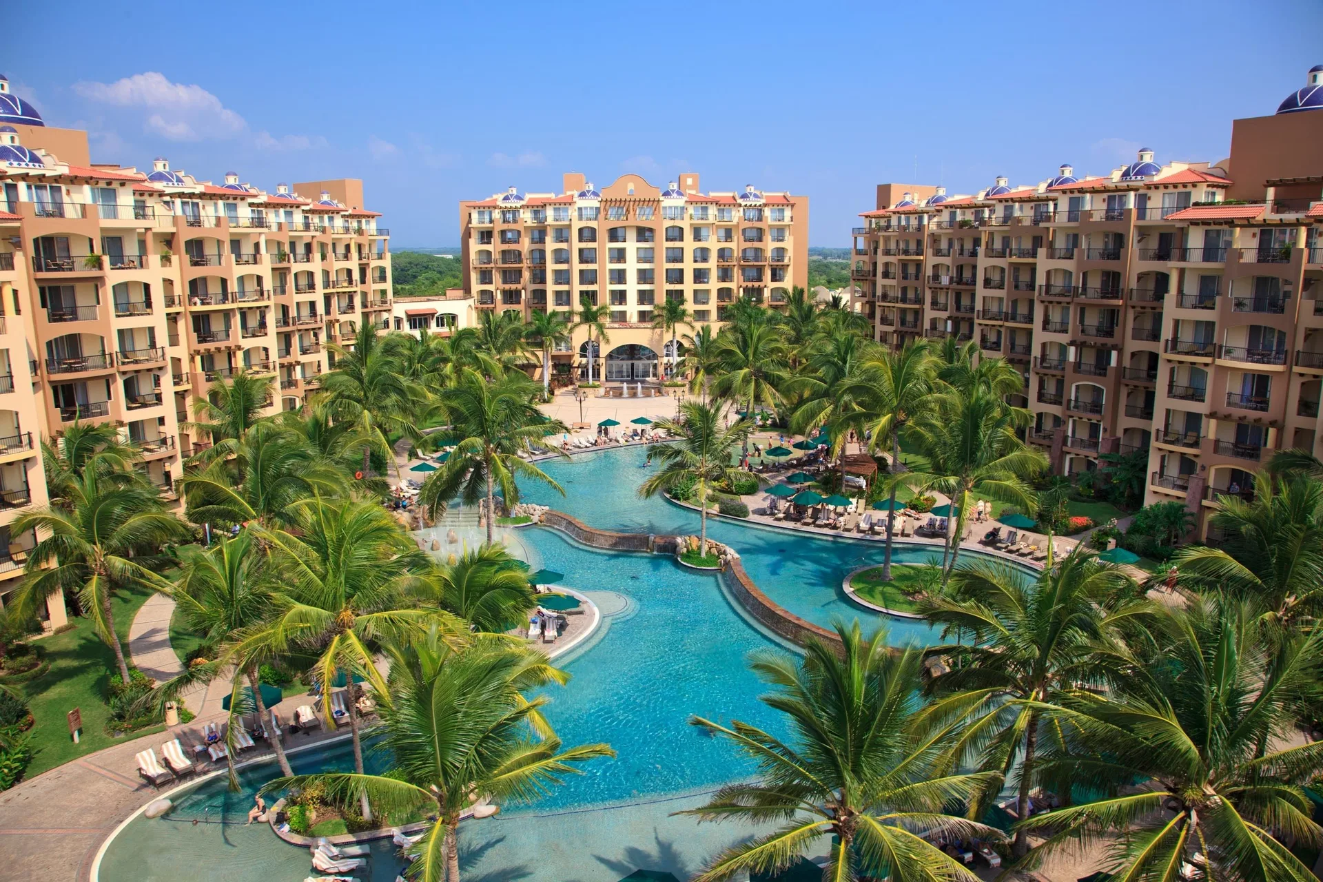 Palm-lined pool courtyard at Villa Del Palmar Flamingos Beach Resort and Spa.