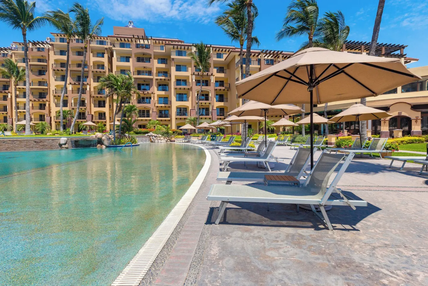 Sun loungers and umbrellas by the pool at Villa Del Palmar Flamingos Beach Resort and Spa