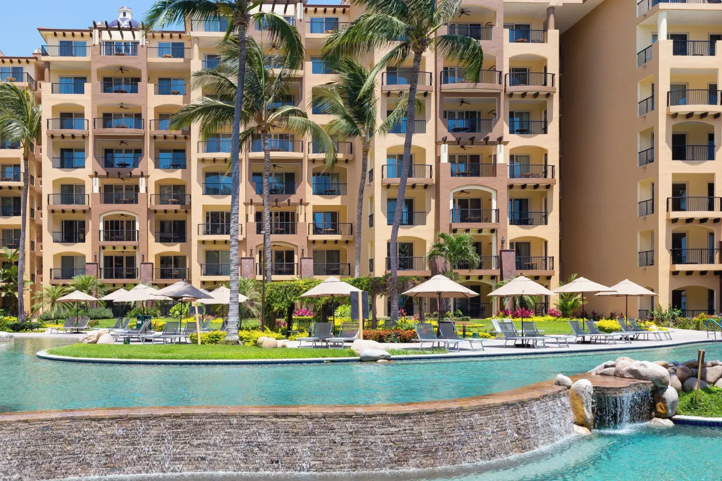 Waterfall edge and pool loungers at Villa Del Palmar Flamingos Beach Resort and Spa