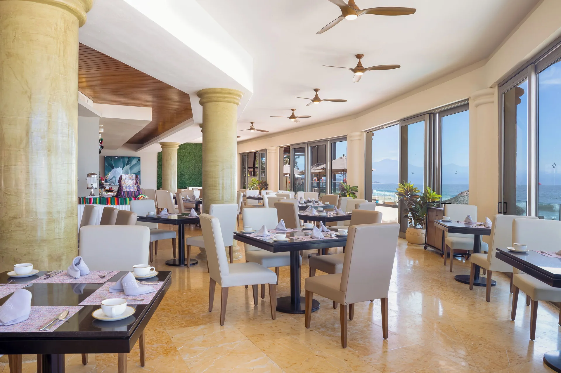 Dining room with large windows and ocean views at Villa Del Palmar Flamingos Beach Resort and Spa.