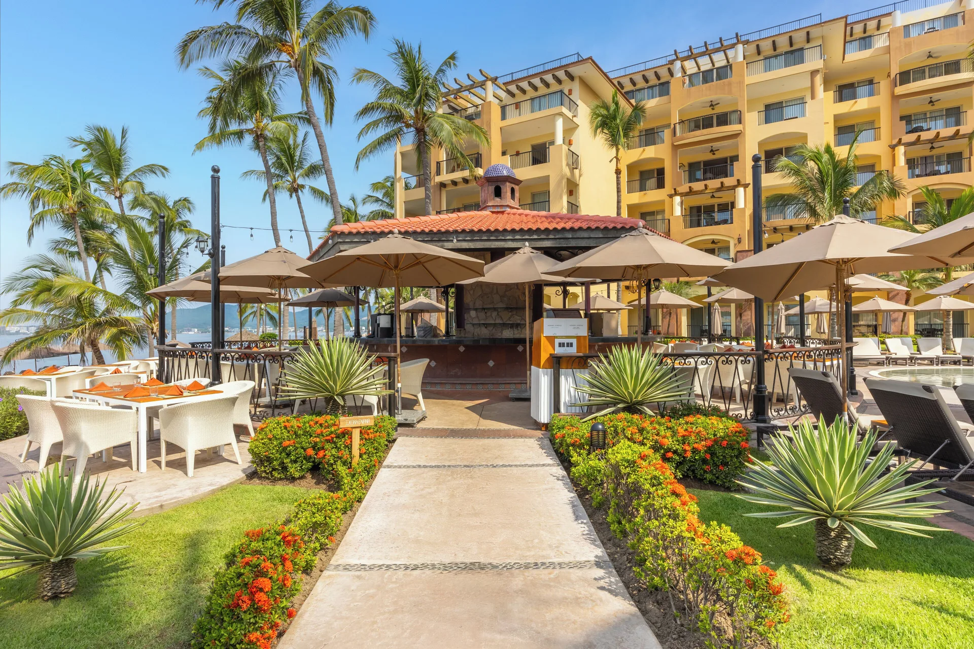 Poolside bar pavilion and garden walkway at Villa Del Palmar Flamingos Beach Resort and Spa.