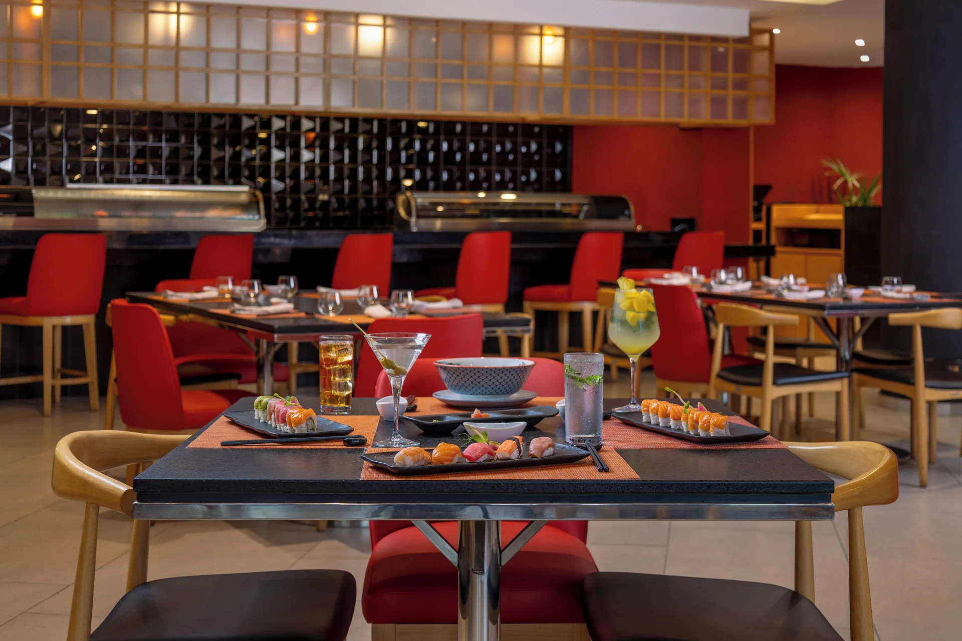 A sushi dining table faces the restaurant counter at Villa Del Palmar Flamingos Beach Resort and Spa.