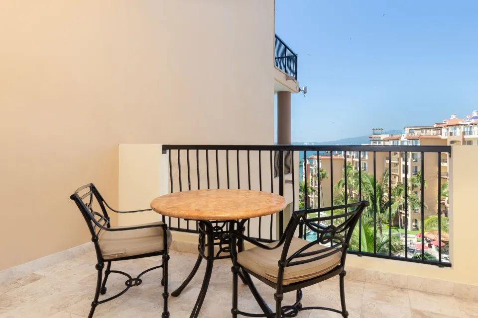 Junior Suite balcony with table and chairs at Villa Del Palmar Flamingos Beach Resort and Spa.