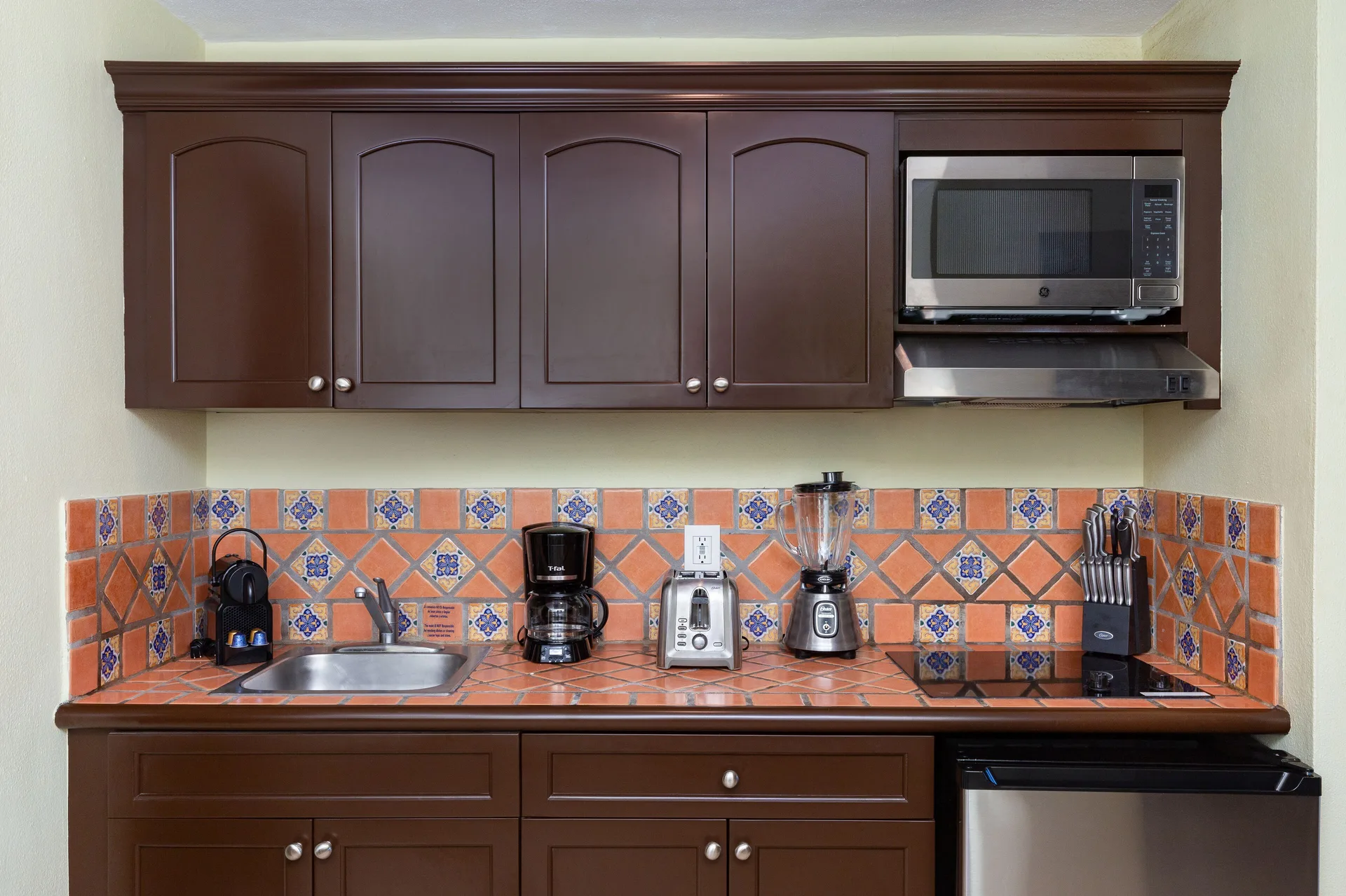 Junior Suite kitchenette with cabinets and appliances at Villa Del Palmar Flamingos Beach Resort and Spa.