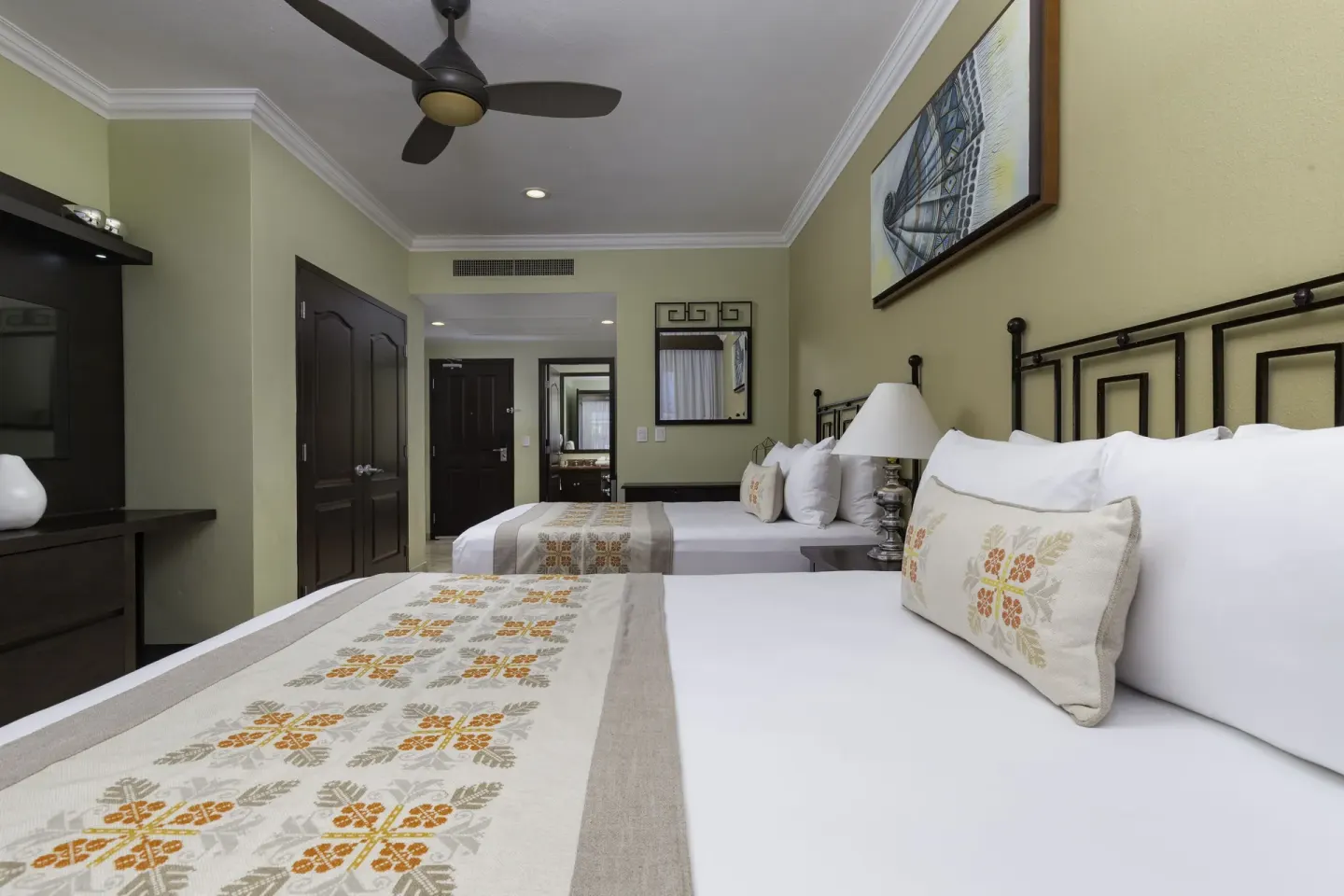 Junior Suite with two beds and wall-mounted TV at Villa Del Palmar Flamingos Beach Resort and Spa.