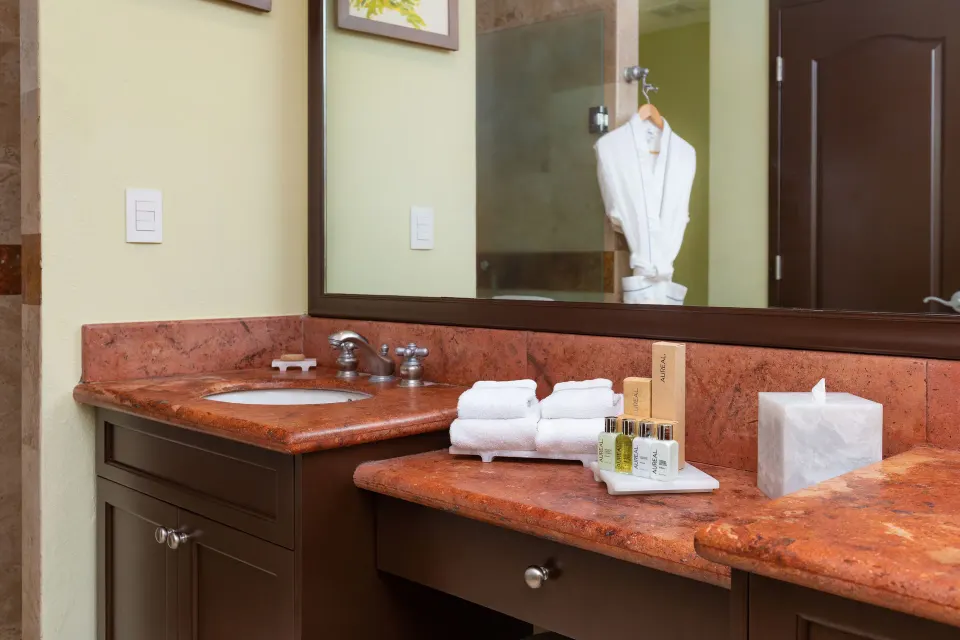One Bedroom Suite vanity with towels and bath amenities at Villa Del Palmar Flamingos Beach Resort and Spa.