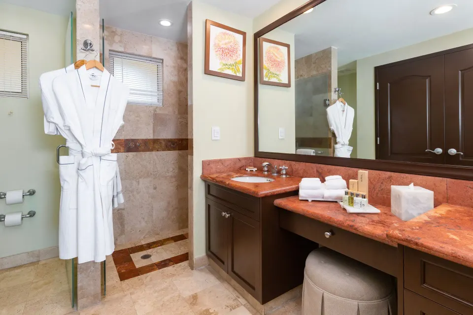 One Bedroom Suite bathroom with vanity and robe at Villa Del Palmar Flamingos Beach Resort and Spa.