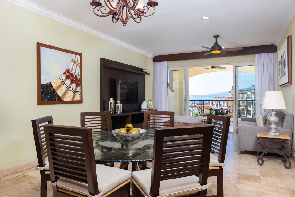 One Bedroom Suite dining table and balcony doors at Villa Del Palmar Flamingos Beach Resort and Spa.