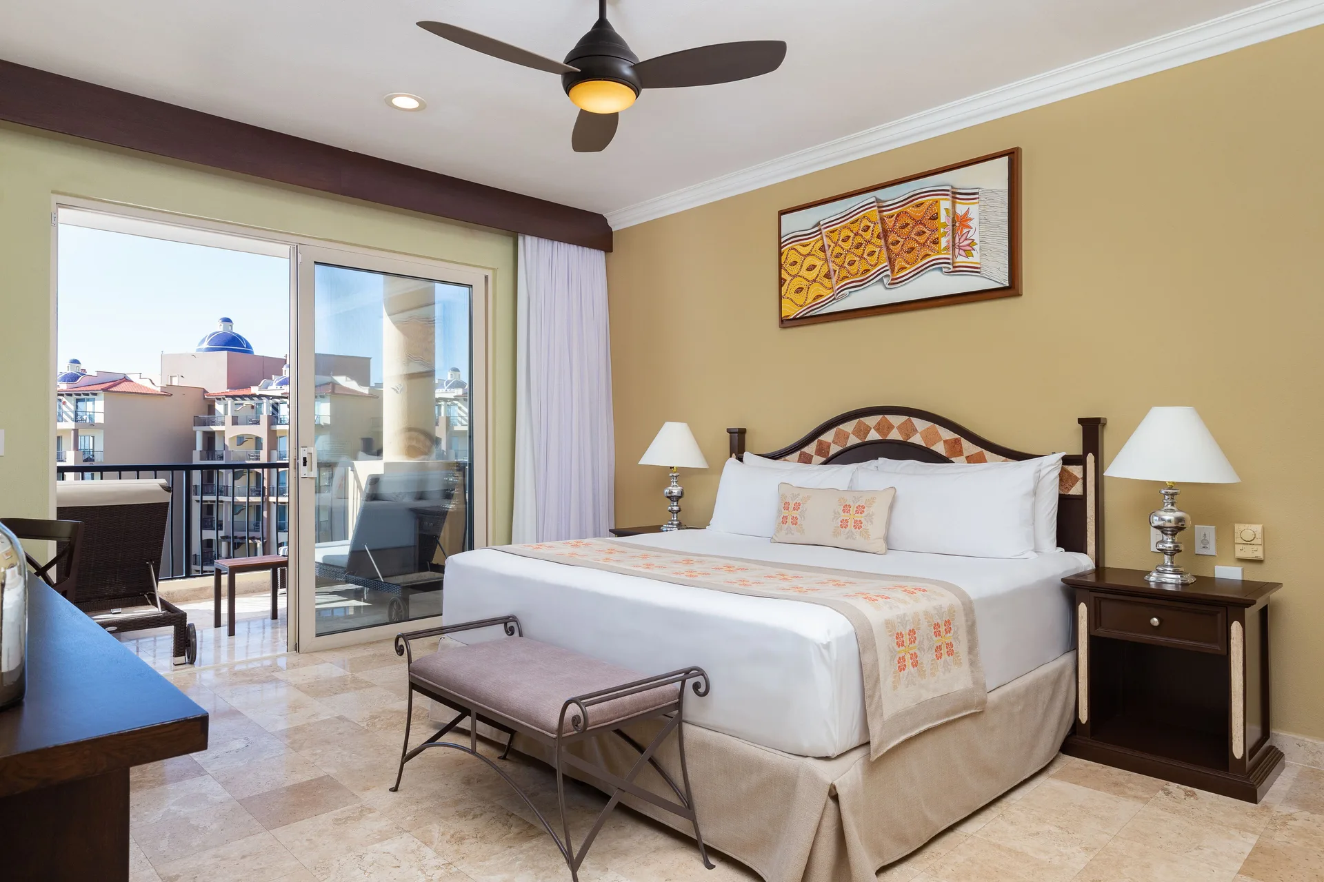 One Bedroom Suite king bed with balcony doors at Villa Del Palmar Flamingos Beach Resort and Spa.