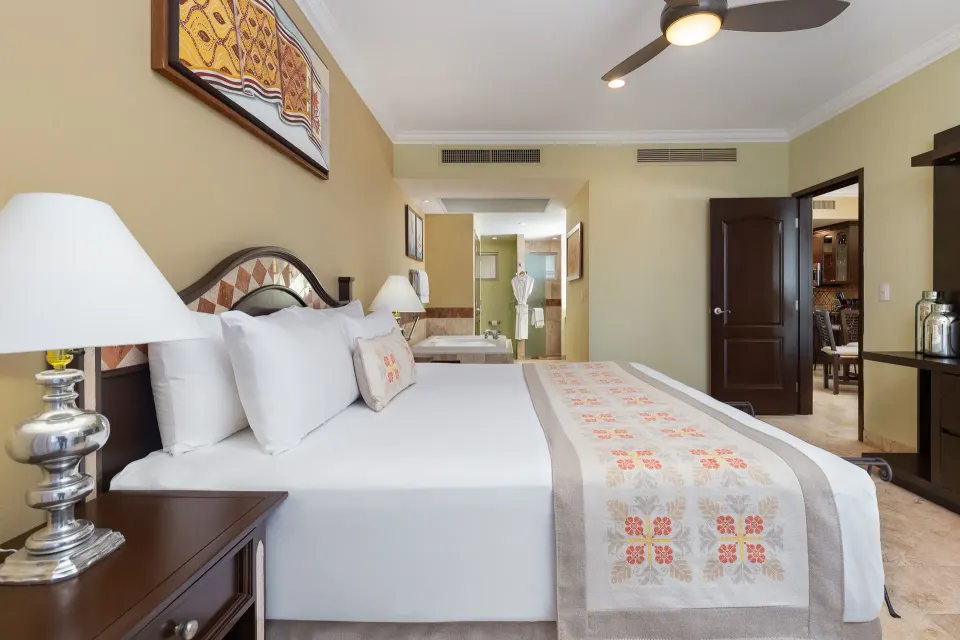 One Bedroom Suite king bed and open bathroom at Villa Del Palmar Flamingos Beach Resort and Spa.