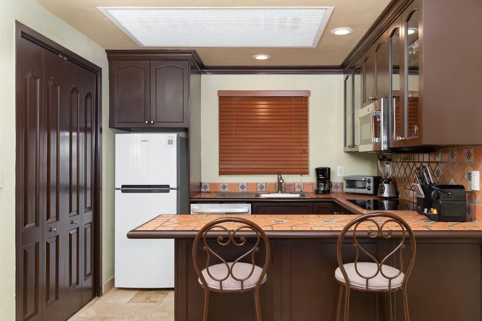 One Bedroom Suite kitchen with breakfast bar at Villa Del Palmar Flamingos Beach Resort and Spa.