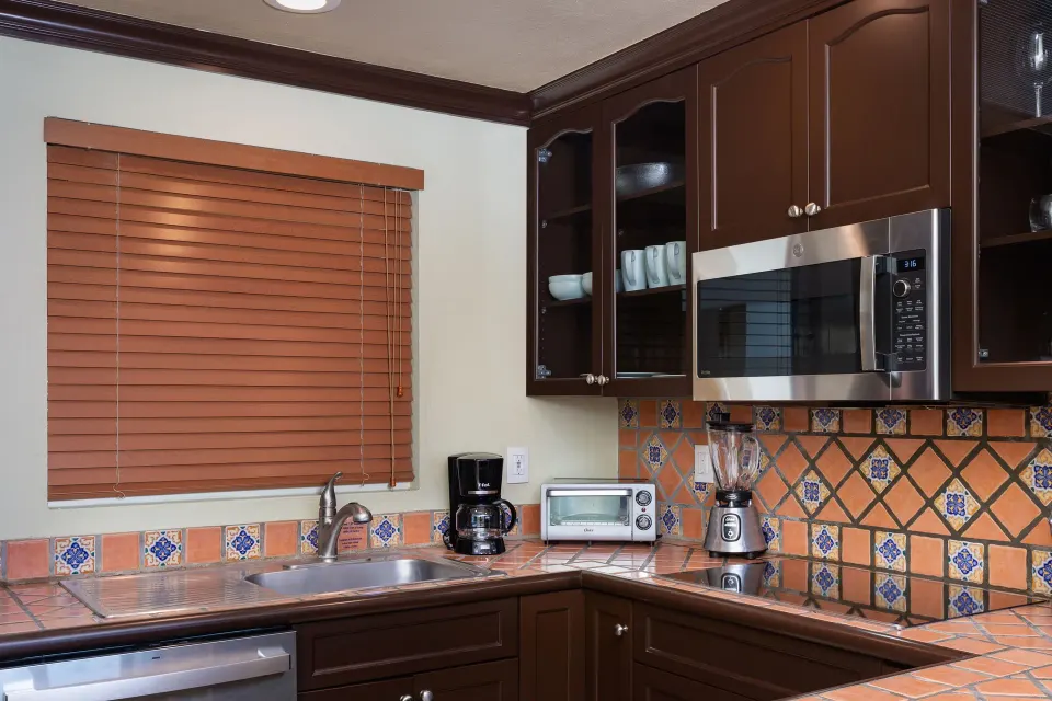 One Bedroom Suite kitchen sink and appliances at Villa Del Palmar Flamingos Beach Resort and Spa.