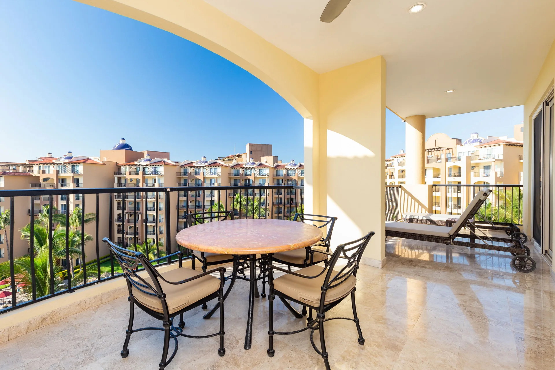 Two Bedroom Suite balcony with dining table and lounge chair at Villa Del Palmar Flamingos Beach Resort and Spa.
