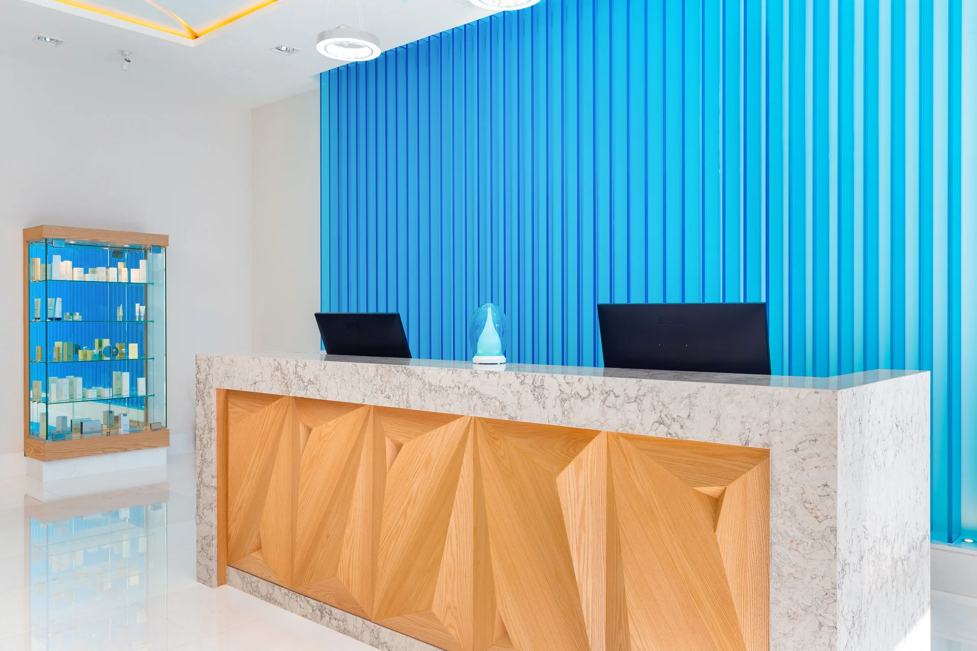 Spa reception desk with blue wall panels at Villa La Valencia Los Cabos Beach Resort & Spa.