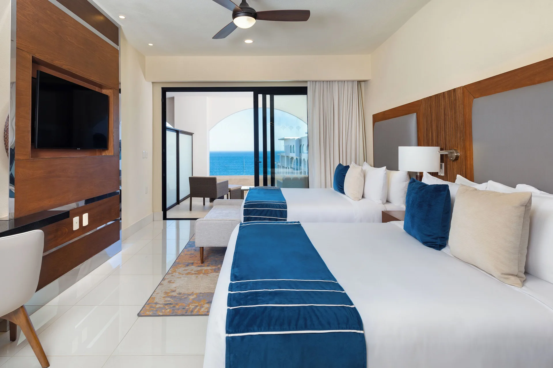 Deluxe Studio Ocean View at Villa La Valencia Los Cabos with two beds, modern décor, and ocean view ambiance in San José del Cabo.