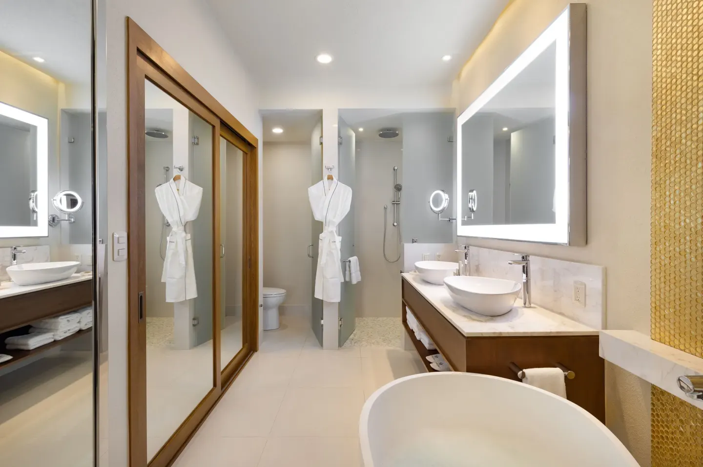Deluxe Studio bathroom with tub, dual sinks, and shower at Villa La Valencia Los Cabos Beach Resort & Spa.