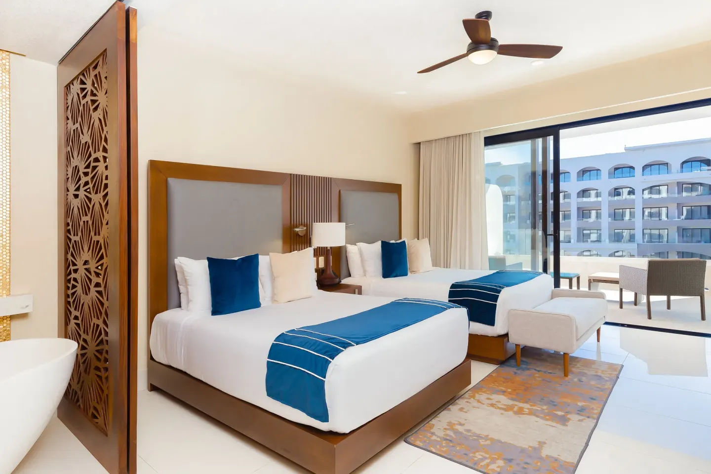 Deluxe Studio Pool View with two beds and balcony seating at Villa La Valencia Los Cabos Beach Resort & Spa.
