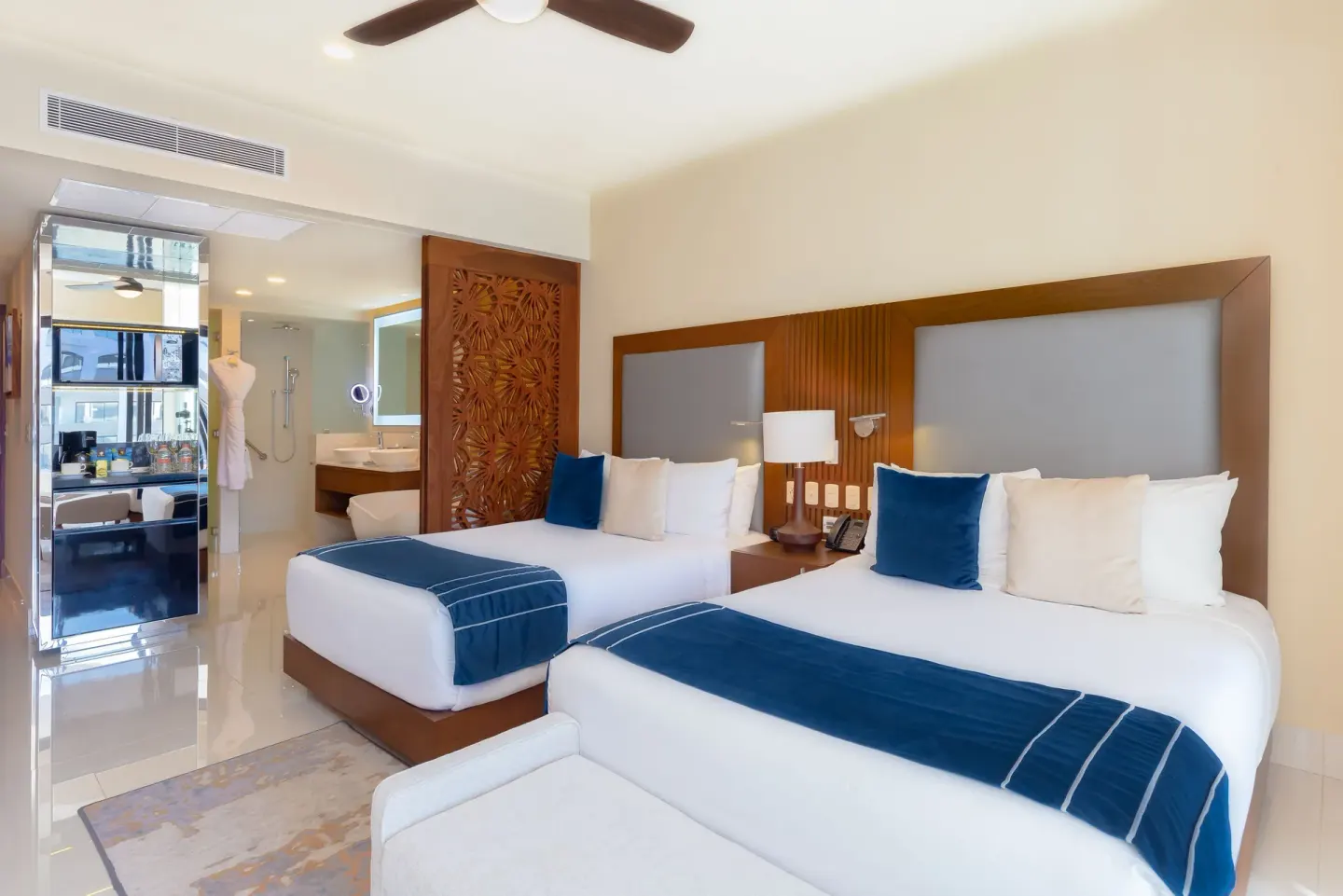 Deluxe Studio Pool View with two beds and open bathroom area at Villa La Valencia Los Cabos Beach Resort & Spa.