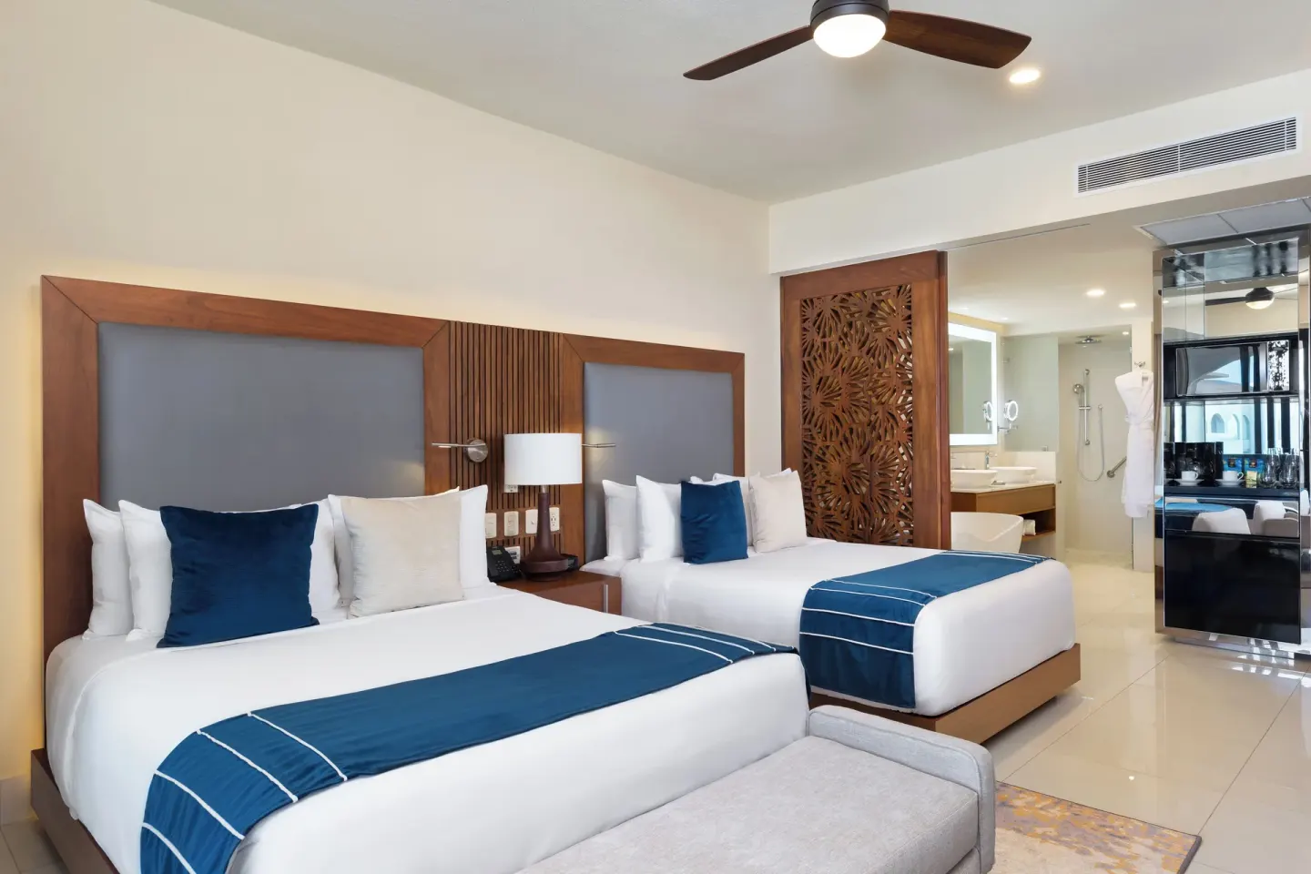 Deluxe Studio Pool View with two beds and vanity area at Villa La Valencia Los Cabos Beach Resort & Spa.