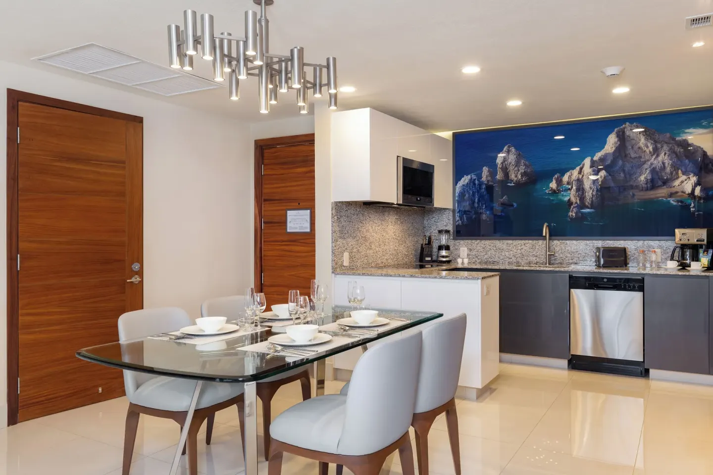 Dining table and kitchen in a One Bedroom Suite Pool View at Villa La Valencia Los Cabos Beach Resort & Spa.