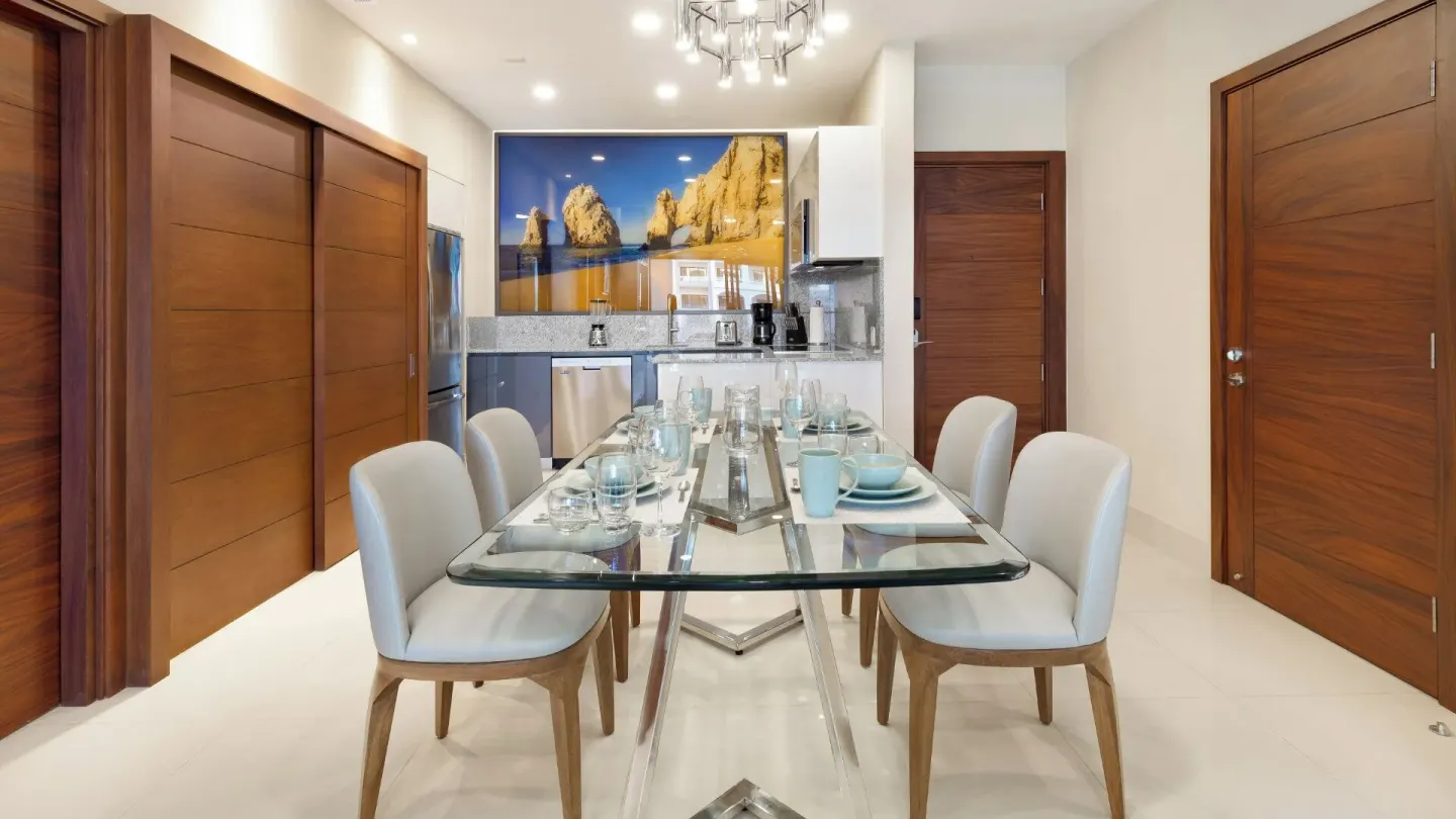 One Bedroom Suite Pool View dining area at Villa La Valencia Los Cabos Beach Resort & Spa with table and kitchenette.