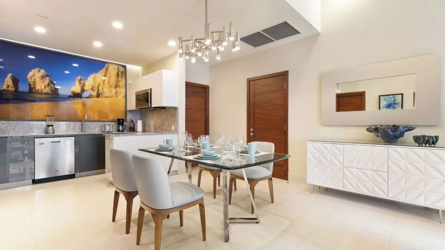 Dining area, kitchen, and sideboard in a One Bedroom Suite Pool View at Villa La Valencia Los Cabos Beach Resort & Spa.