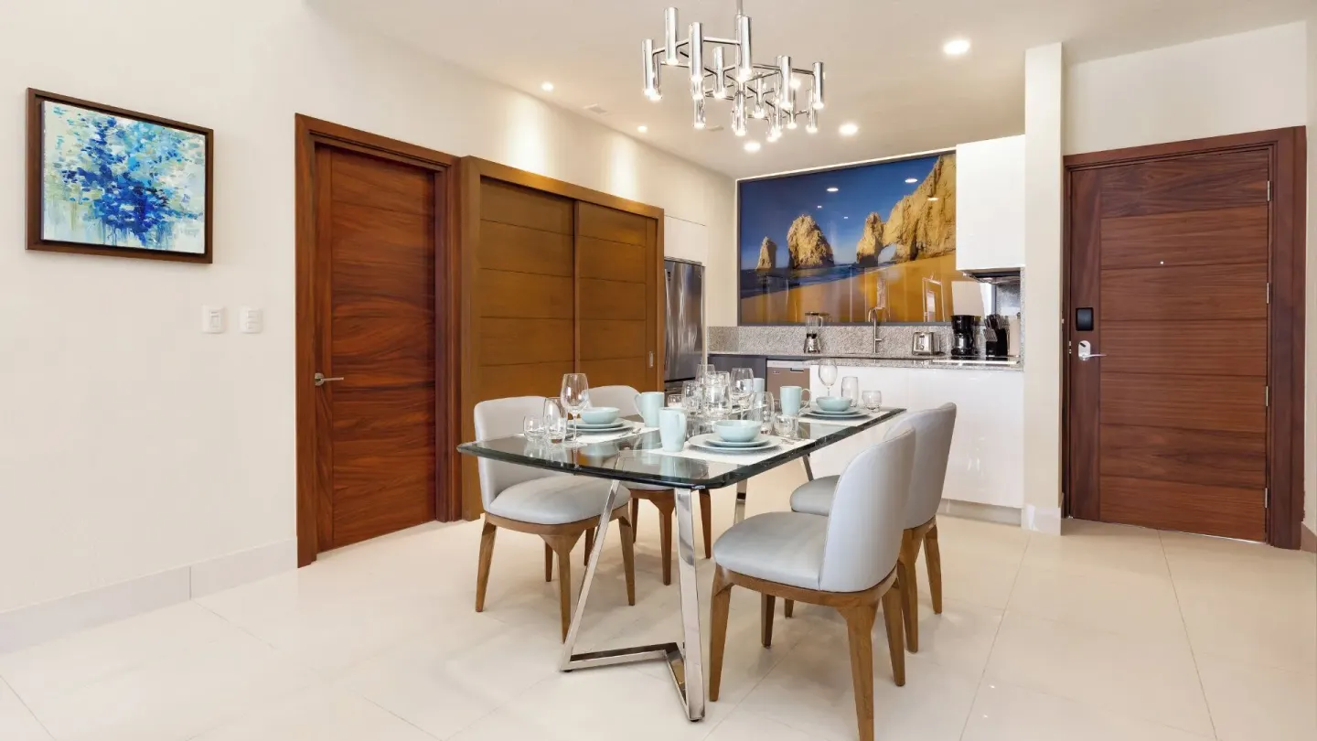 Set dining table and kitchen entry in a One Bedroom Suite Pool View at Villa La Valencia Los Cabos Beach Resort & Spa.