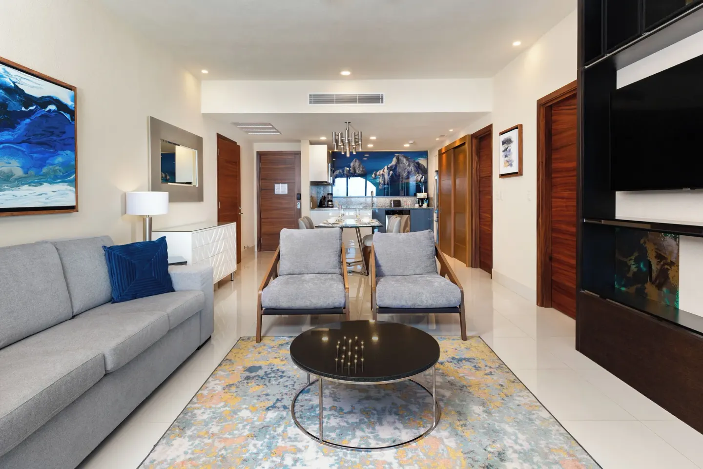 One Bedroom Suite Pool View living area at Villa La Valencia Los Cabos Beach Resort & Spa with sofa and dining area.