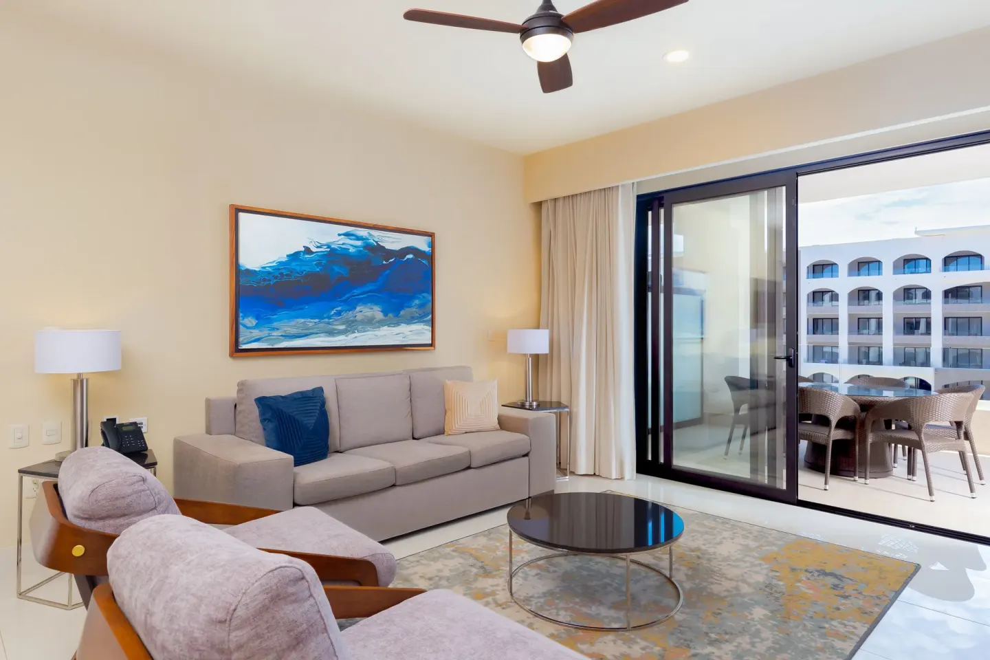Living room with balcony seating in a One Bedroom Suite Pool View at Villa La Valencia Los Cabos Beach Resort & Spa.
