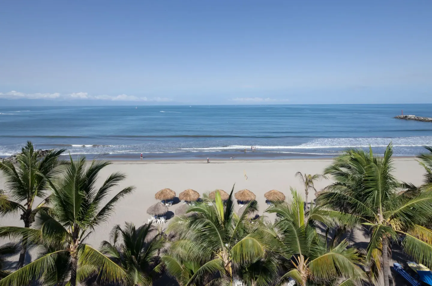 Beachfront palms and ocean waves at Villa Varadero.