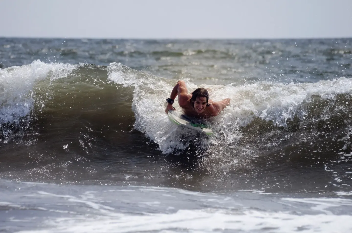 A bodyboarder rides through a breaking wave off the beach at Villa Varadero.