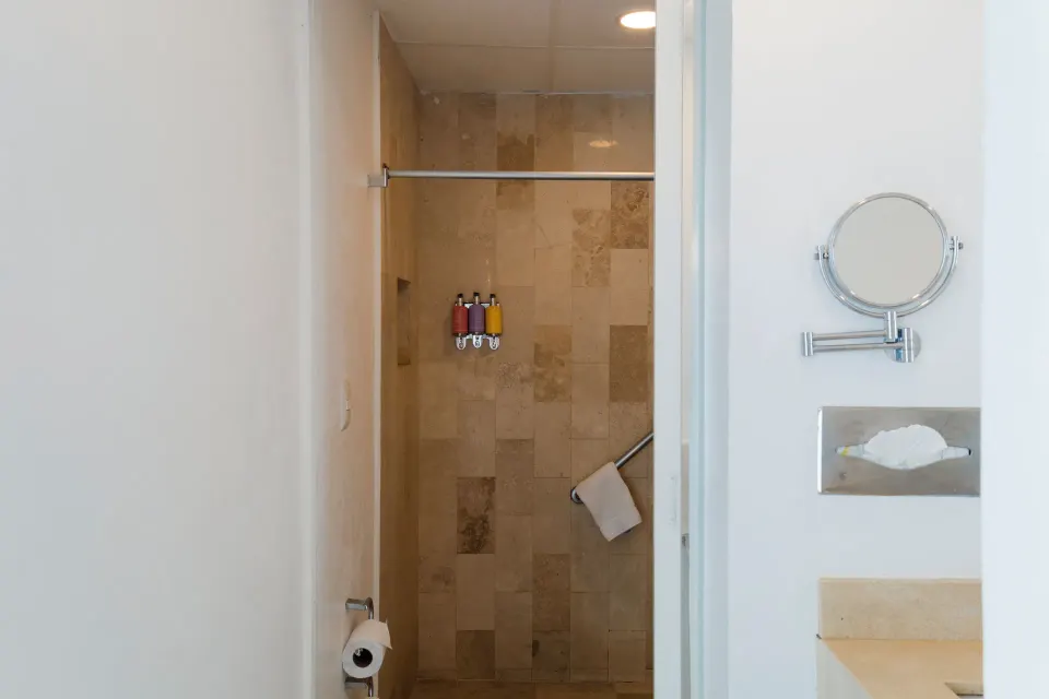 Standard Room shower area with tiled wall and vanity details at Villa Varadero.