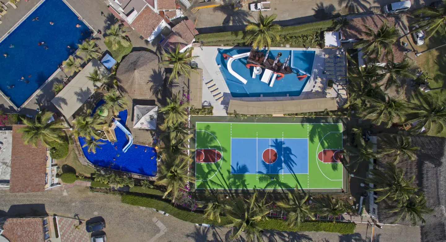 Aerial view of pools, waterslides, and sports court at Vista Playa de Oro Manzanillo.