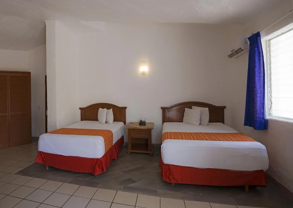 Two double beds in a guest room at Vista Playa de Oro Manzanillo.